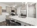 Modern kitchen features stainless steel appliances and an island with a granite countertop at 3402 Pelican Ln, Durham, NC 27703
