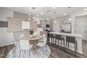 Open-concept kitchen and dining area with a granite island and modern decor at 3402 Pelican Ln, Durham, NC 27703