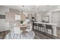 Open-concept dining area features stylish lighting and a modern table set for six at 3406 Pelican Ln, Durham, NC 27703