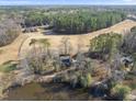 Aerial view of a home adjacent to a scenic pond and golf course at 4041 Wendy Ln, Zebulon, NC 27597