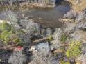 Aerial view of a home surrounded by lush trees and a scenic marsh at 4041 Wendy Ln, Zebulon, NC 27597