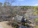 Aerial view of a home nestled among lush trees, beside a serene lake at 4041 Wendy Ln, Zebulon, NC 27597