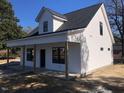Charming white two-story home with a welcoming front porch and black trim windows at 412 N Green St, Selma, NC 27576