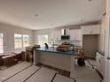 Well-lit kitchen with white cabinets, modern fixtures, and a breakfast bar at 45 Trescott St, Smithfield, NC 27577