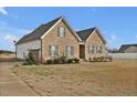 Beautiful home featuring brick and siding, complemented by a well-manicured lawn and lush greenery at 4840 Baines Loop Rd, Spring Hope, NC 27882