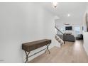 Bright foyer with hardwood floors, elegant console table, and open staircase leading to the living area at 4840 Baines Loop Rd, Spring Hope, NC 27882