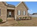 Inviting front porch with a classic brick facade and decorative shutters on the windows at 4840 Baines Loop Rd, Spring Hope, NC 27882