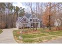 Desirable home with mature trees, a spacious lawn, and a long driveway at 659 Willard Dr, Creedmoor, NC 27522