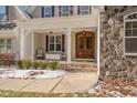 Inviting front porch features comfortable seating and stone accents at 659 Willard Dr, Creedmoor, NC 27522