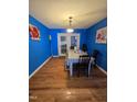 Bright dining room with wood flooring, with a pendant light fixture and access to the backyard at 701 Grandview Drive Dr, Durham, NC 27703