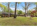A charming brick home features classic architecture with a lush lawn and a convenient carport for parking at 714 W J St, Erwin, NC 28339
