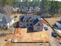 An aerial view shows the home and lot, highlighting the spacious yard and neighborhood at 7412 Wexford Woods Ln, Wake Forest, NC 27587