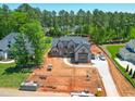 Expansive aerial view of a new home with landscaping in progress, showcasing the property's spacious surroundings at 7412 Wexford Woods Ln, Wake Forest, NC 27587