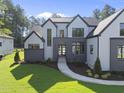 Beautiful two-story home with gray accents, manicured lawn and a winding walkway at 7412 Wexford Woods Ln, Wake Forest, NC 27587