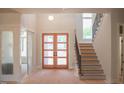 Bright foyer featuring a modern double door entry and staircase, all awaiting finishing touches at 7412 Wexford Woods Ln, Wake Forest, NC 27587