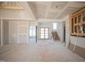 Large living room with a grand entry, high ceilings and staircase awaiting finishes at 7412 Wexford Woods Ln, Wake Forest, NC 27587