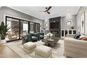 Modern living room featuring a fireplace, ceiling fan, and elegant decor at 8621 Bishop Pine Ln, Wake Forest, NC 27587