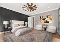 Cozy bedroom with a large bed, stylish rug, and a modern ceiling fan at 8621 Bishop Pine Ln, Wake Forest, NC 27587