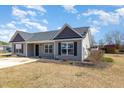 Single-story house features a well-kept lawn, tidy landscaping, and a solid concrete driveway at 107 Rollingwood Cir, Kenly, NC 27542