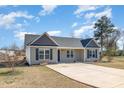 Inviting single-story house with manicured lawn, a concrete driveway, and a classic design at 107 Rollingwood Cir, Kenly, NC 27542