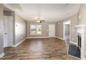 Inviting living room featuring modern wood flooring, neutral paint, and a cozy fireplace at 107 Rollingwood Cir, Kenly, NC 27542