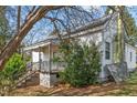 Exterior view of the home featuring a side porch and mature landscaping at 110 W Elm St, Nashville, NC 27856