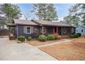 Inviting home exterior showcasing a well-manicured lawn, walkway and a covered front porch at 1729 Augustus Dr, Rocky Mount, NC 27801