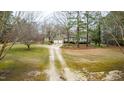 Beautiful home with an expansive front yard and long driveway, surrounded by lush trees and greenery at 2010 Twin Acres Rd, Clayton, NC 27520
