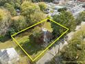 Aerial view of a charming home with a large yard in a neighborhood, property lines are estimated at 219 N Richardson Ave, Nashville, NC 27856