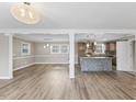 Open floor plan featuring luxury vinyl plank flooring, modern lighting, and a view of the kitchen at 2605 Sumac Ln, Burlington, NC 27215