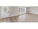 View of bright, open living area featuring luxury vinyl plank flooring and a stylish front door at 2605 Sumac Ln, Burlington, NC 27215
