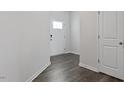 Bright entryway with durable wood flooring and white trim, leading to the rest of the home at 266 Hanging Elm Ln, Fuquay Varina, NC 27526