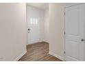 Foyer features wood flooring, a white front door with glass panels, and a coat closet at 266 Hanging Elm Ln, Fuquay Varina, NC 27526