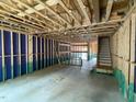 Unfinished basement of a house showcasing the bare framework, staircase, and under-construction elements at 4073 Elk Creek Ln, Raleigh, NC 27612