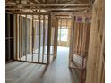 Unfinished living room showcasing the bare framework, windows, and under-construction elements at 4073 Elk Creek Ln, Raleigh, NC 27612