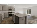 Modern kitchen with granite countertops, stainless steel appliances, and hardwood floors at 425 Citron St, Sanford, NC 27332