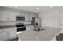 Kitchen featuring granite countertops, stainless appliances, and a large island with sink at 429 Citron St, Sanford, NC 27332