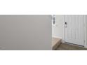 Bright entryway with a solid white front door and stairs with carpet at 433 Citron St, Sanford, NC 27332