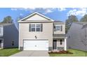 Charming two-story home features a one-car garage, neutral siding, and manicured landscaping at 433 Citron St, Sanford, NC 27332