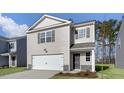 Charming two-story home features a one-car garage, neutral siding, and manicured landscaping at 433 Citron St, Sanford, NC 27332