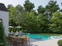 Inviting pool area with outdoor dining and lounge seating surrounded by mature trees and manicured landscaping at 5301 Inglewood Ln, Raleigh, NC 27609