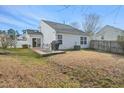 Spacious backyard with a deck, mature trees, and ample space for outdoor activities at 5548 Roan Mountain Pl, Raleigh, NC 27613