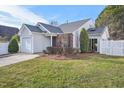 Well-maintained exterior with a manicured lawn, a fenced yard, and a cozy outdoor space at 5548 Roan Mountain Pl, Raleigh, NC 27613