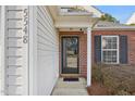 Inviting front door framed by brick and siding, adding charm to the home's entrance at 5548 Roan Mountain Pl, Raleigh, NC 27613