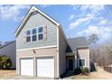 Charming two-story home with a two-car garage and well-maintained front lawn at 5627 Quitman Trl, Raleigh, NC 27610