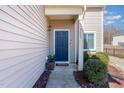 Inviting front entrance with a blue door, neat landscaping, and a 'Welcome' mat at 5627 Quitman Trl, Raleigh, NC 27610