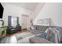 Bright living room with high ceilings, a large gray sofa, and stylish decor at 5627 Quitman Trl, Raleigh, NC 27610