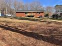 Expansive backyard featuring a raised wooden deck and lush lawn, perfect for outdoor entertaining at 613 Sexton Ave, Zebulon, NC 27597