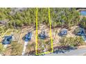 Aerial view of home showcasing wooded lot, surrounding neighborhood, and proximity to nearby lake at 6935 Old Jefferson Hwy, Cameron, NC 28326