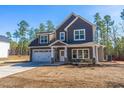 Charming two-story home with gray siding, stone accents, and a well-manicured yard at 6935 Old Jefferson Hwy, Cameron, NC 28326